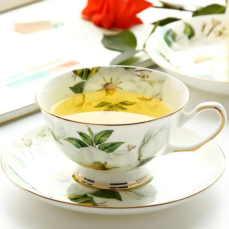 "White Camellia" fine bone china tea cup filled with golden tea, styled with a red rose — CL House & Home