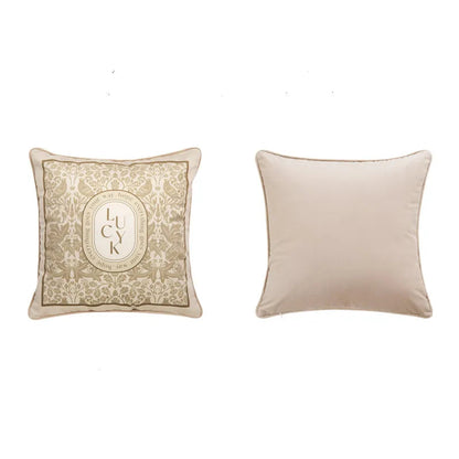 "Lucky Bloom" botanical velvet square cushion cover front and back view, warm beige ground with golden floral damask and typographic LUCK medallion, plain cream velvet reverse — CL House Cushions collection