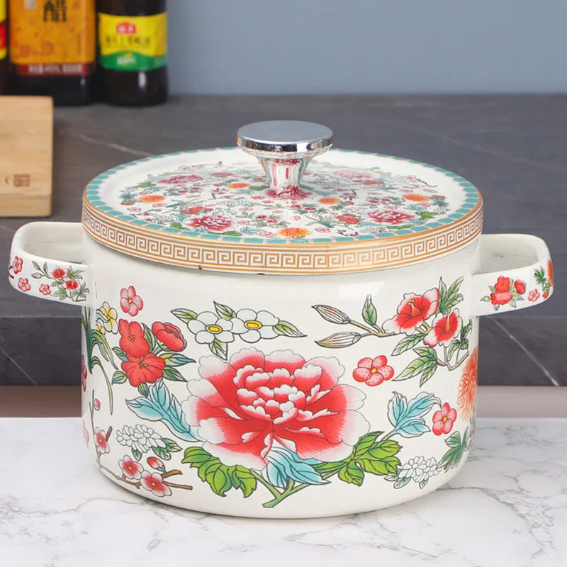  Floral enamel casserole with lid, Peony Garden design — bold red peonies, white cherry blossoms and mixed blooms on cream enamel, teal and gold Greek key border, styled on marble kitchen surface — Peony Garden by CL House