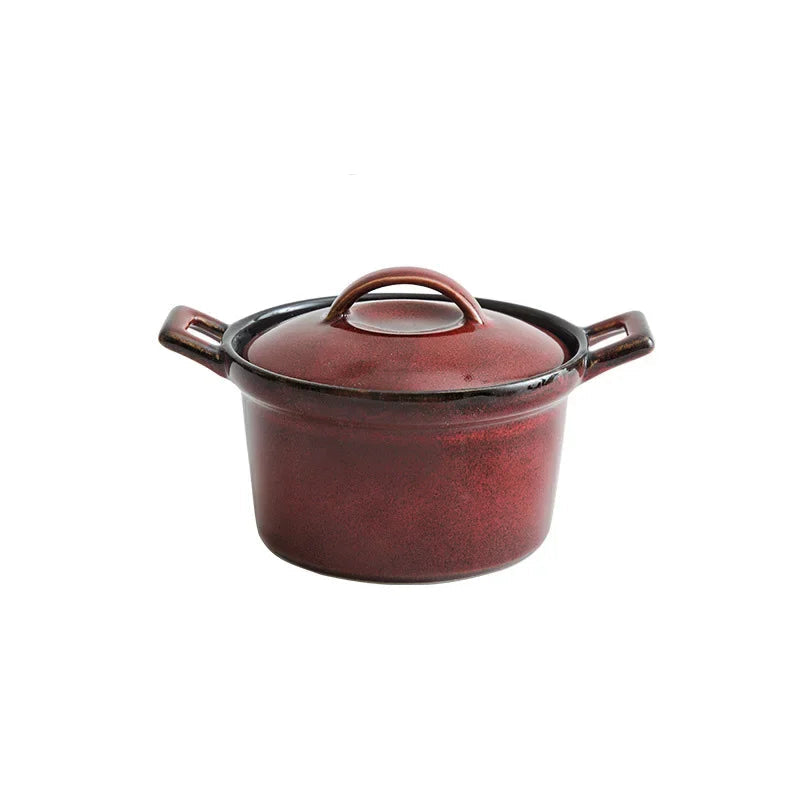  Reactive glaze ceramic casserole with lid, Crimson Ember finish — deep burgundy red speckled glaze with dark rim and handles, round knob lid, white background — Stone Vessel by CL House