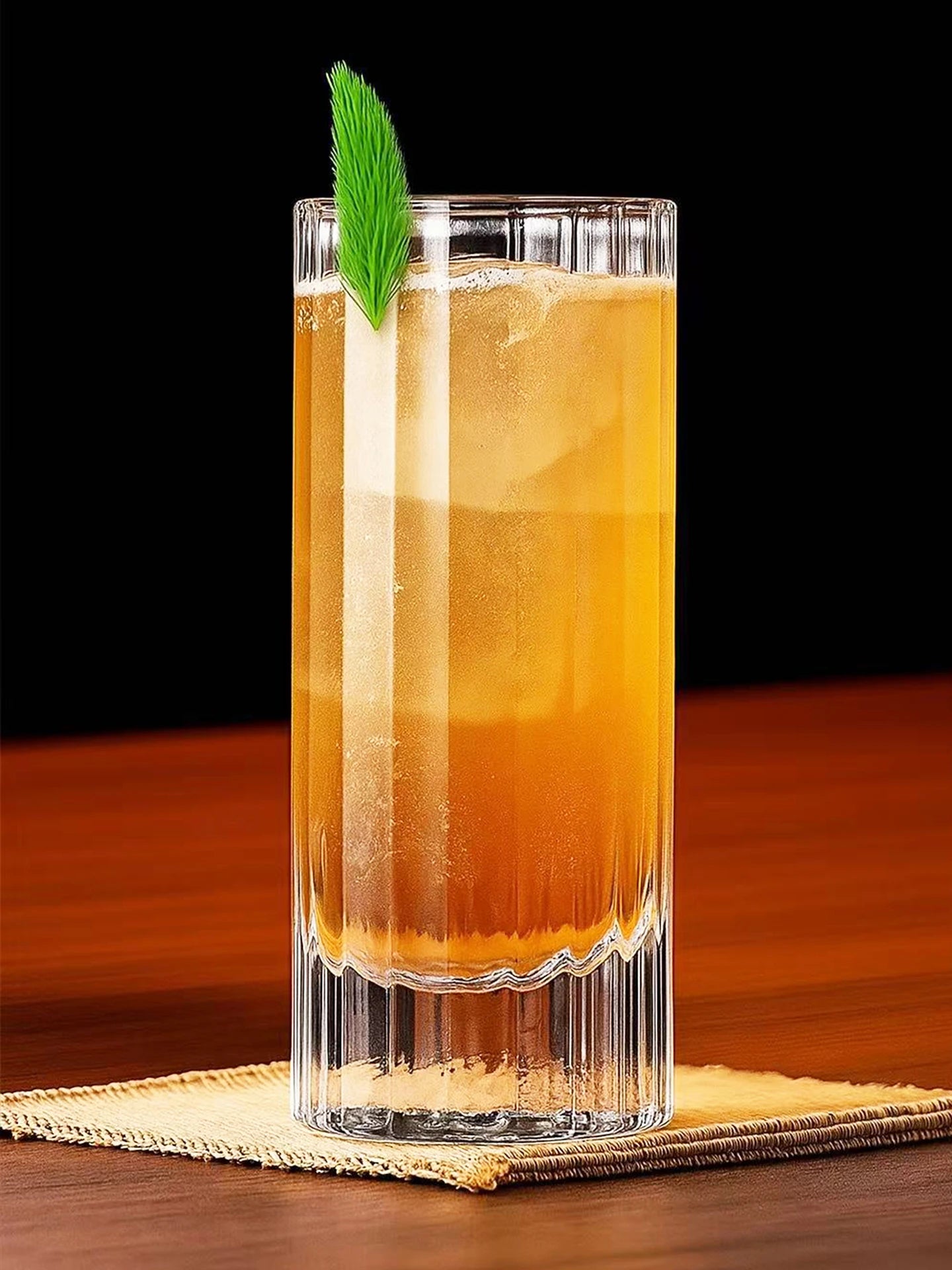 "Fluted Column" crystal highball glass filled with a cocktail, elegant fluted column design — CL House Drinkware collection