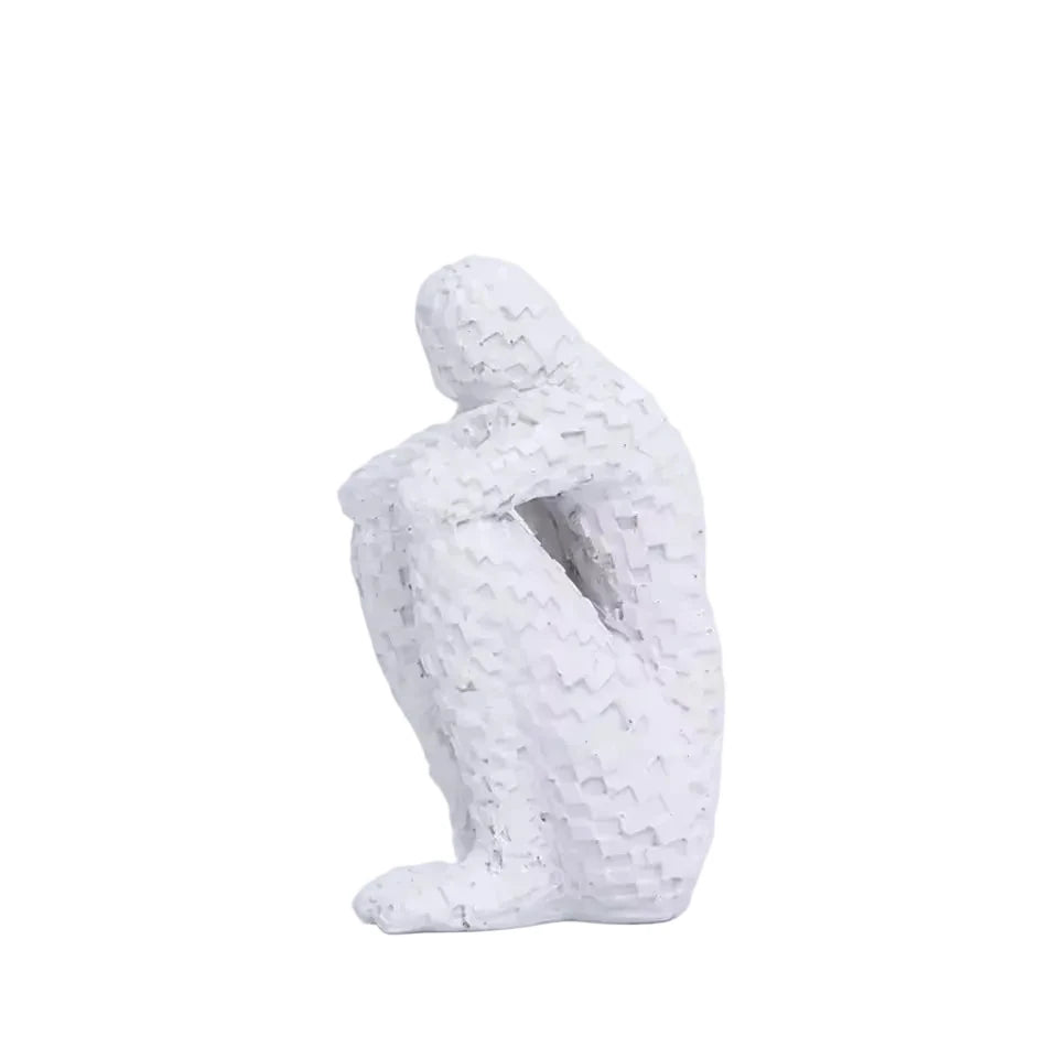 White mosaic resin figure sculpture in a seated, contemplative pose on a white background.