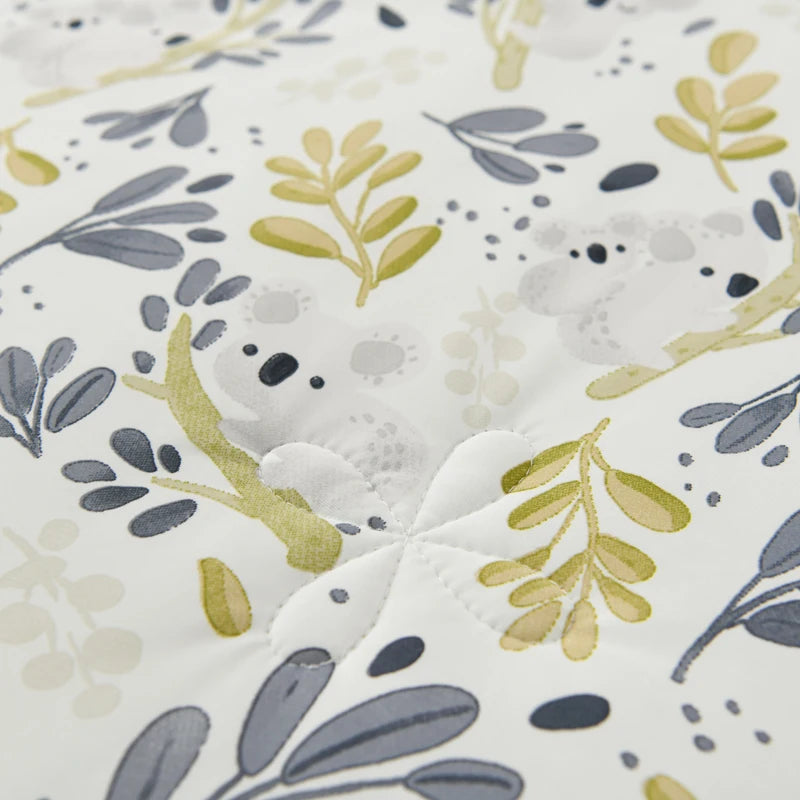 Close-up of Willow Garden ice silk cooling summer quilt showing detailed botanical leaf print with hidden koala motif and quilted stitching texture