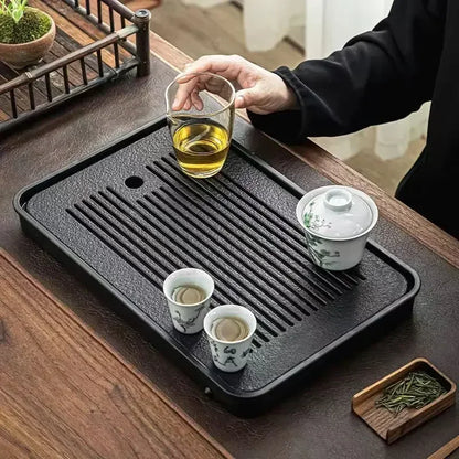 Gongfu Cha Pan Stone Drainage Tea Tray – linear groove design, lifestyle shot with glass cup, gaiwan and teacups | CL House