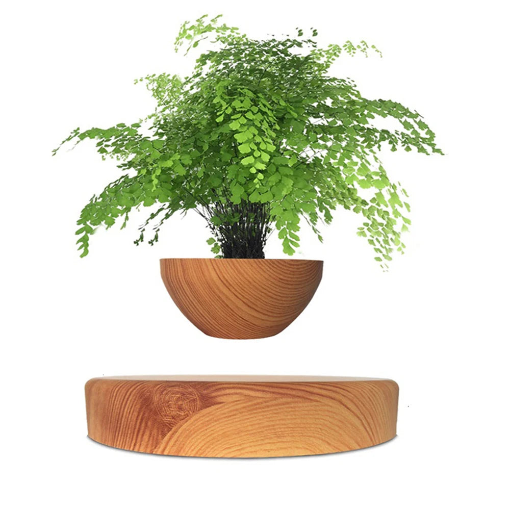 Levitating bonsai pot Magnetic suspension planter Floating flower pot Air bonsai rotation Novelty magnetic planter Home decor technology Unique plant display Kinetic planter Rotating flower pot