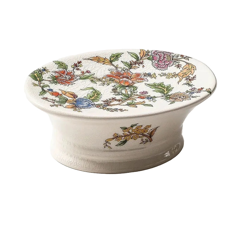 Oval pedestal ceramic soap dish with colourful chinoiserie garden botanical print, crackle-glaze finish, angled view on white background