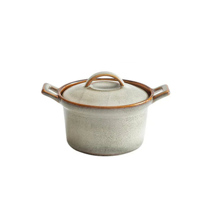  Reactive glaze ceramic casserole with lid, Sand Stone finish — warm cream speckled glaze with amber brown rim and handles, round knob lid, white background — Stone Vessel by CL House