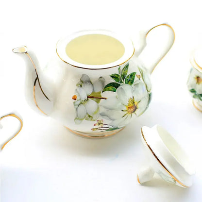 "White magnolia bone china teapot with gold trim on ceramic warmer stand, 900ml — CL House Tea Time collection"