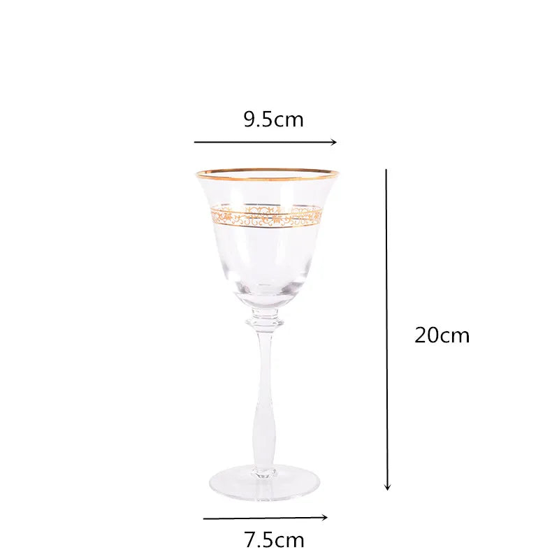 Single crystal wine glass with gold filigree rim and engraved band, front view on white background — 9.5cm wide, 20cm tall