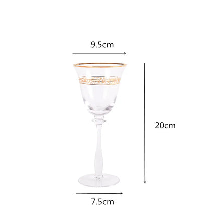 Single crystal wine glass with gold filigree rim and engraved band, front view on white background — 9.5cm wide, 20cm tall