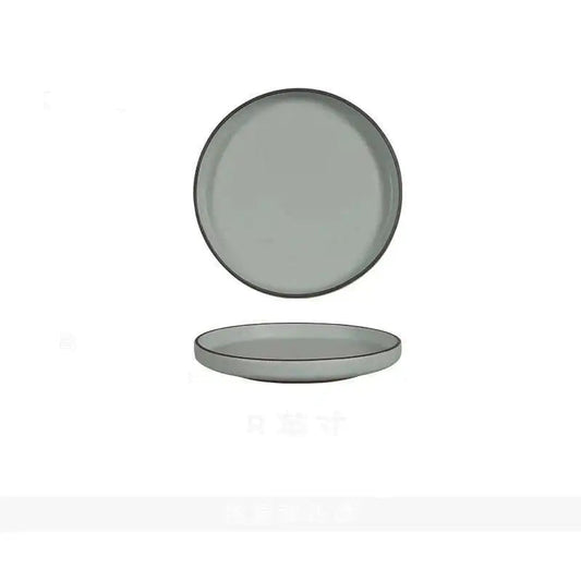  "Spiral Sand" ceramic dinner plate in mist grey with matte finish and straight raised edge — top view and side profile on white background

Próxima! 📷