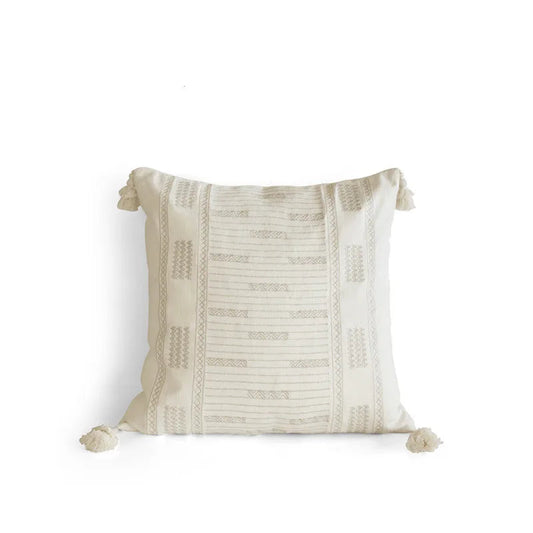 Ivory tassel square cushion cover with geometric jacquard weaving and hand-knotted corner tassels, photographed on a white background — handcrafted ramie-linen blend, boho Japandi home decor.
