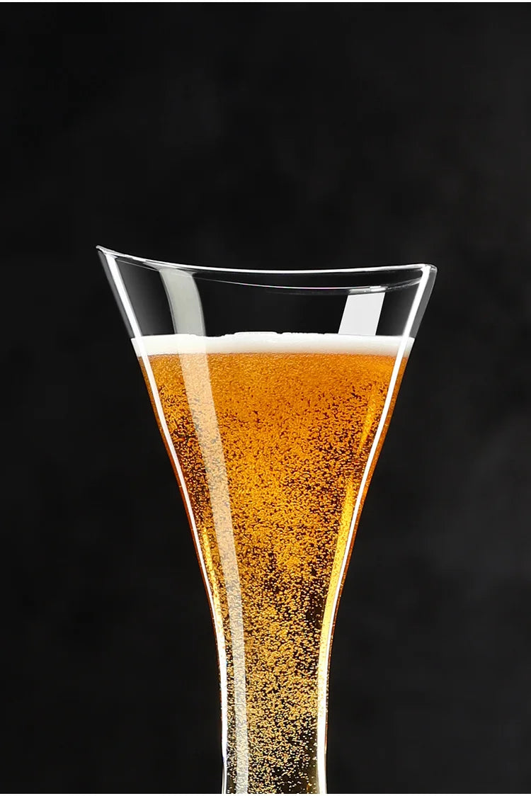  Close-up of the "Trumpet" crystal champagne flute rim filled with champagne, delicate bubbles visible — CL House Drinkware collection
