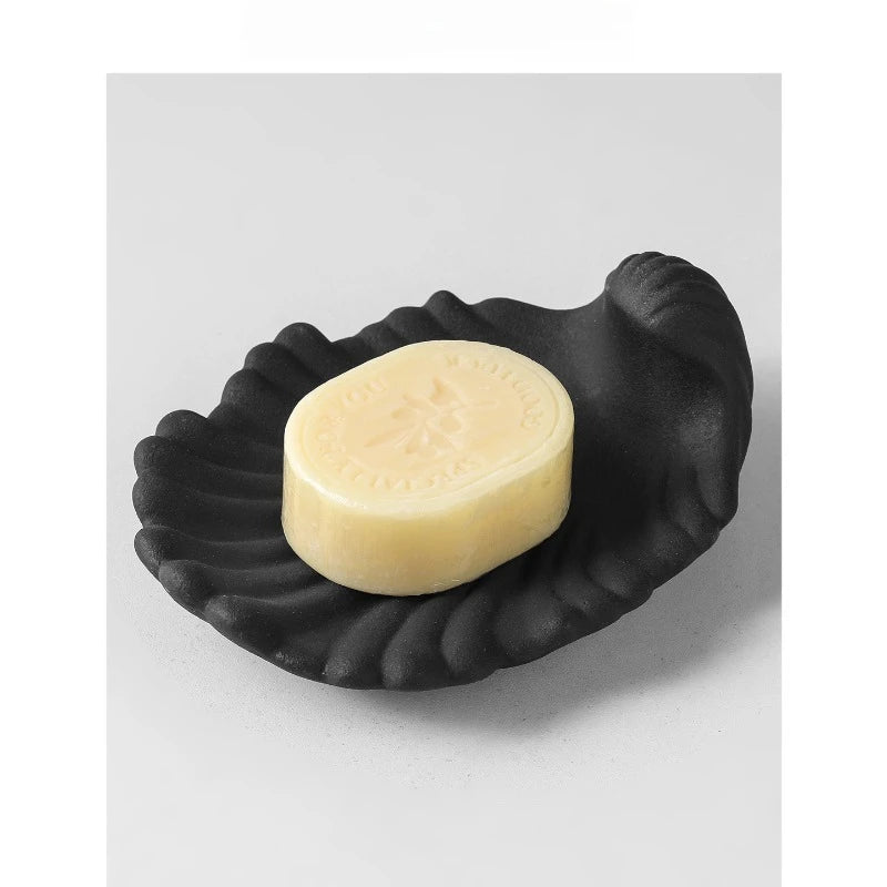  Chalk white matte ceramic shell-shaped soap dish, angled view on white background