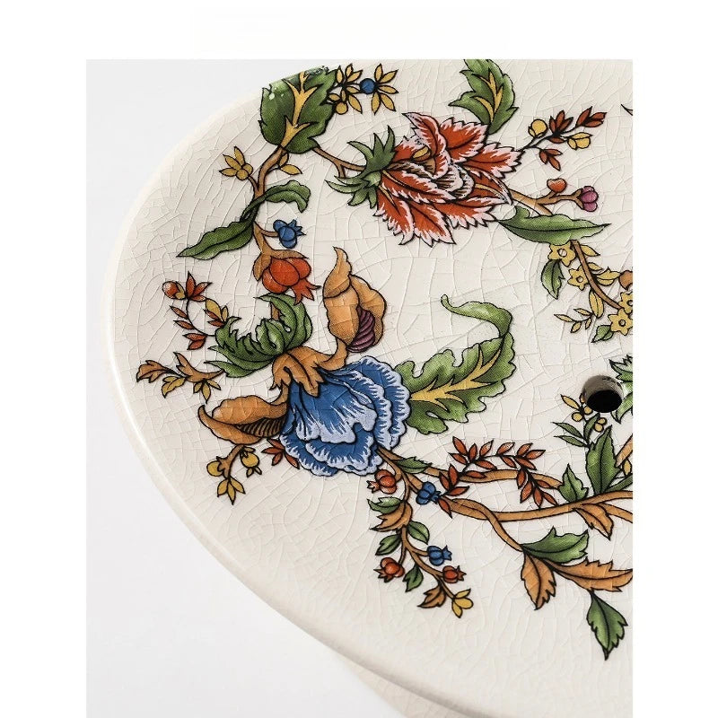  Close-up detail of Chinoiserie Garden oval soap dish showing hand-painted botanical motifs — red peony, blue flower, and trailing vines — with crackle-glaze ceramic texture