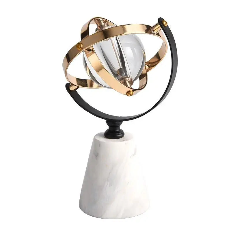 Decorative marble globe with a clear glass sphere and brass and black rings, shown with dimensions of 19 cm tall, an 11 x 11 cm