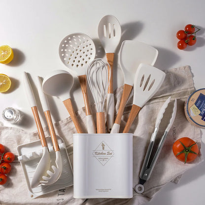 White silicone kitchen utensils set with bamboo handles displayed in storage holder on linen cloth styled with tomatoes, lemon and cheese, CL House & Home