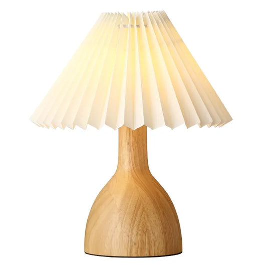 "Pleat & Wood" pleated table lamp with off white shade and vase-shaped wood base, full product view on white background