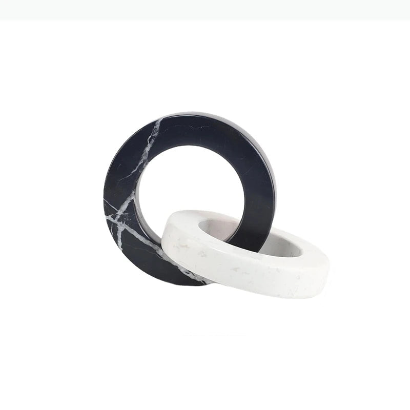 Round black and white interlocking marble sculpture with dimensions of approximately 19.5 by 15 by 15 centimetres.