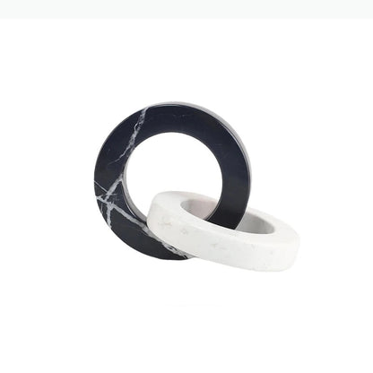 Round black and white interlocking marble sculpture with dimensions of approximately 19.5 by 15 by 15 centimetres.