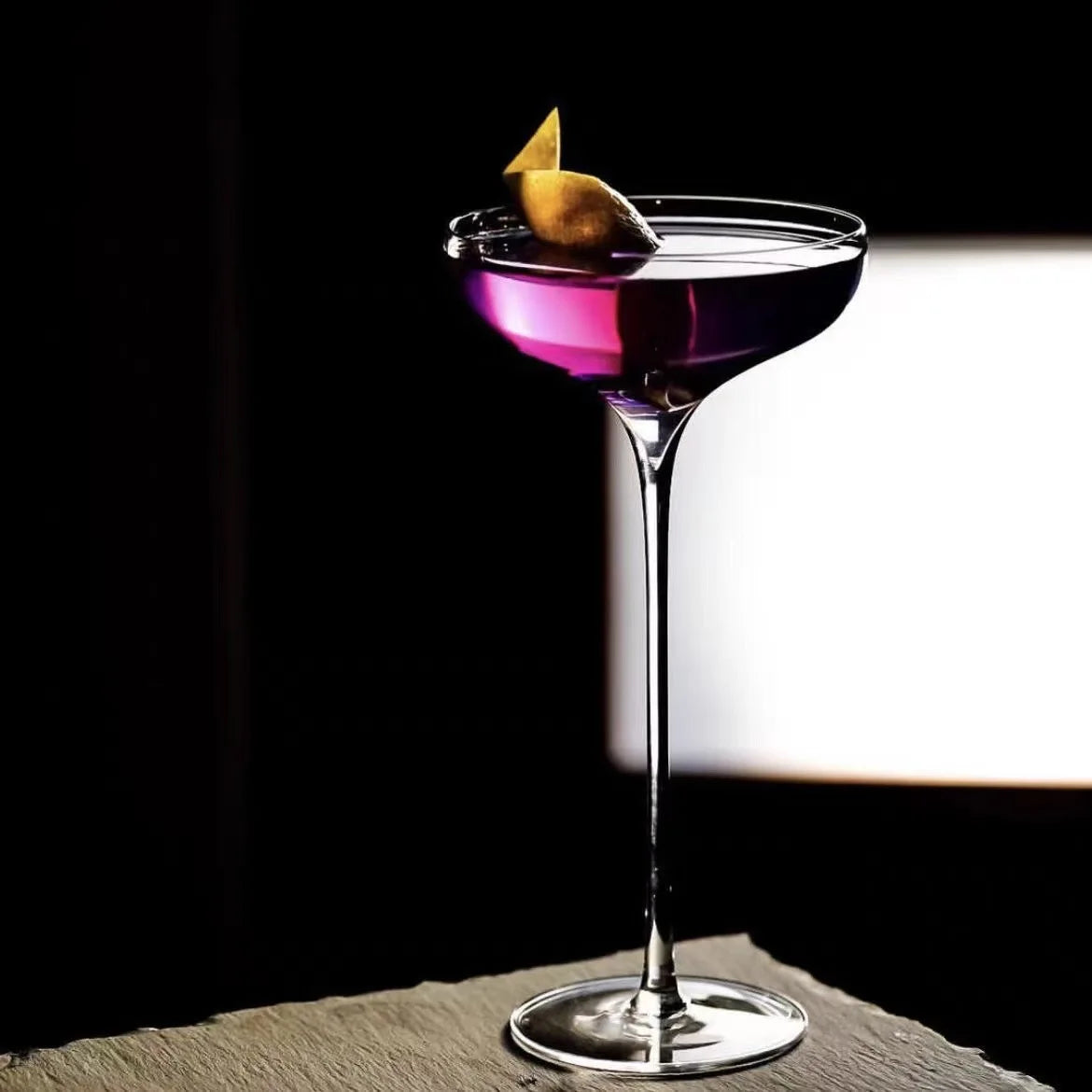 "Long Stem" coupe cocktail glass showcasing a colourful cocktail, elegant wide bowl and elongated stem — CL House Drinkware collection
