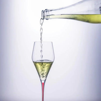  "Ink Line" geometric crystal wine glass with red stem being poured from a bottle, bold geometric design — CL House Drinkware collection