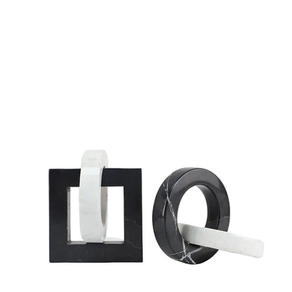 Square and round black and white interlocking marble sculptures displayed side by side on a white background.