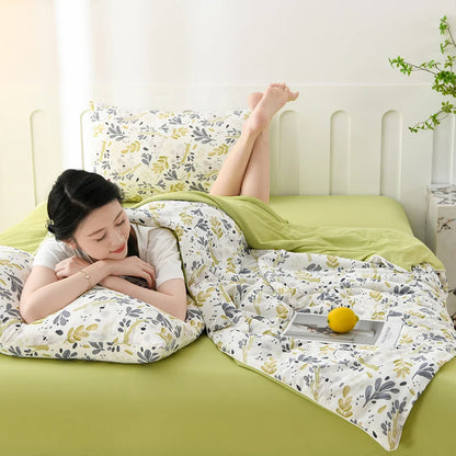 Willow Garden ice silk cooling summer quilt with botanical leaf print on a sage green bed styled with matching pillowcase in a bright airy bedroom