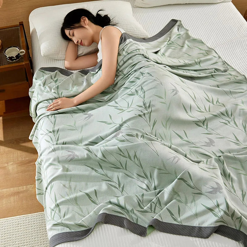 "Woman sleeping under 100% Bamboo Fibre cooling blanket in Willow Mist — sage green willow leaf print, soft and breathable summer bedding for a cool night's sleep"