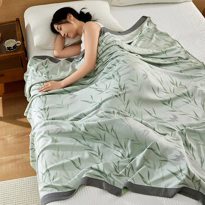 "Woman sleeping under 100% Bamboo Fibre cooling blanket in Willow Mist — sage green willow leaf print, soft and breathable summer bedding for a cool night's sleep"