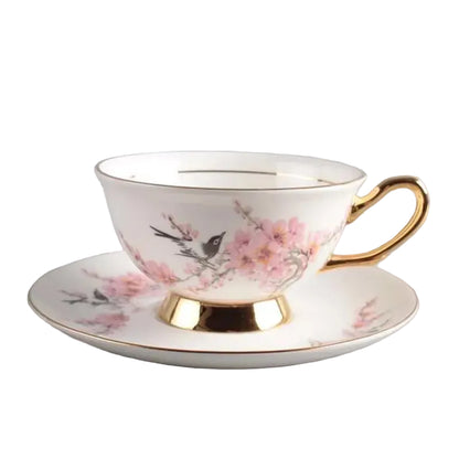  Magnolia & Sparrow:

"White bone china teacup and saucer with magnolia and sparrow print and gold trim  — CL House Tea Time"