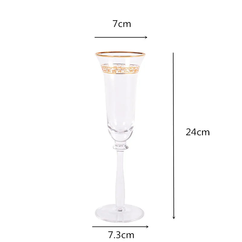 Single crystal champagne flute with gold filigree rim and engraved band, front view on white background — 7cm wide, 24cm tall