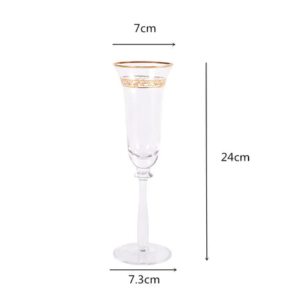 Single crystal champagne flute with gold filigree rim and engraved band, front view on white background — 7cm wide, 24cm tall