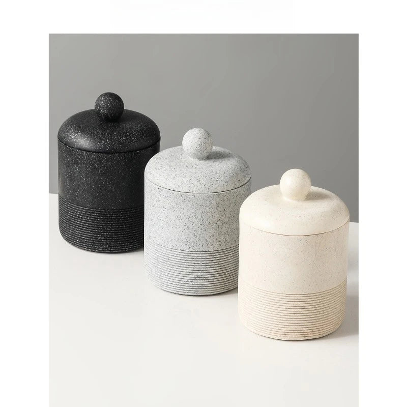 Three Stone Jar ceramic storage jars with lids — Midnight Stone, Slate Stone, and Chalk Stone — arranged in a staggered row on white surface with grey background, showing full range of colourways