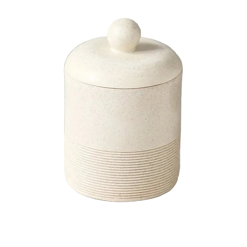 Chalk Stone wabi-sabi ceramic storage jar with domed lid and round ball knob, full front view on white background showing warm cream stone texture and ribbed base detail