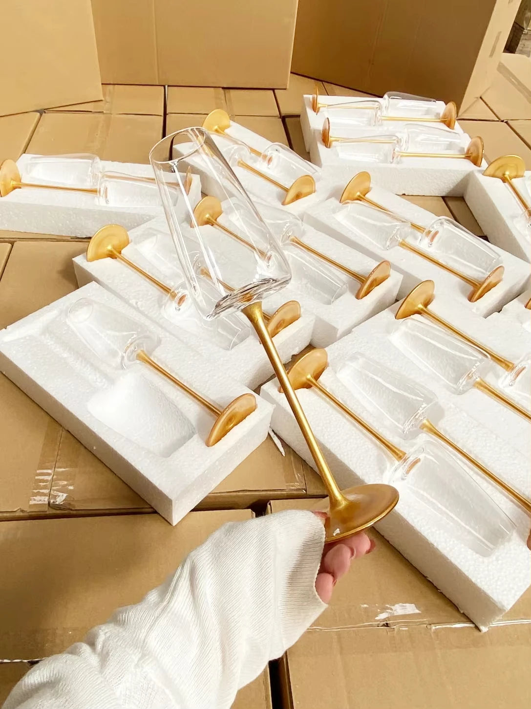  Multiple "Stem & Base" crystal champagne flutes in Golden Stem variant displayed on their packaging boxes — CL House Drinkware collection