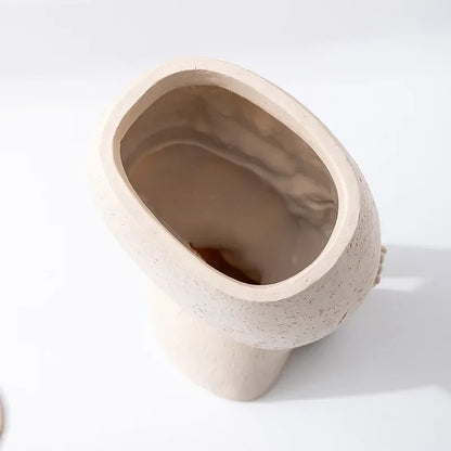 "Hush Muse" sculptural face resin planter top view showing large oval opening and textured ivory cream exterior finish, white background