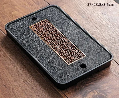 Gongfu Cha Pan Stone Drainage Tea Tray – angled view, round copper honeycomb lattice on dark stone surface | CL House