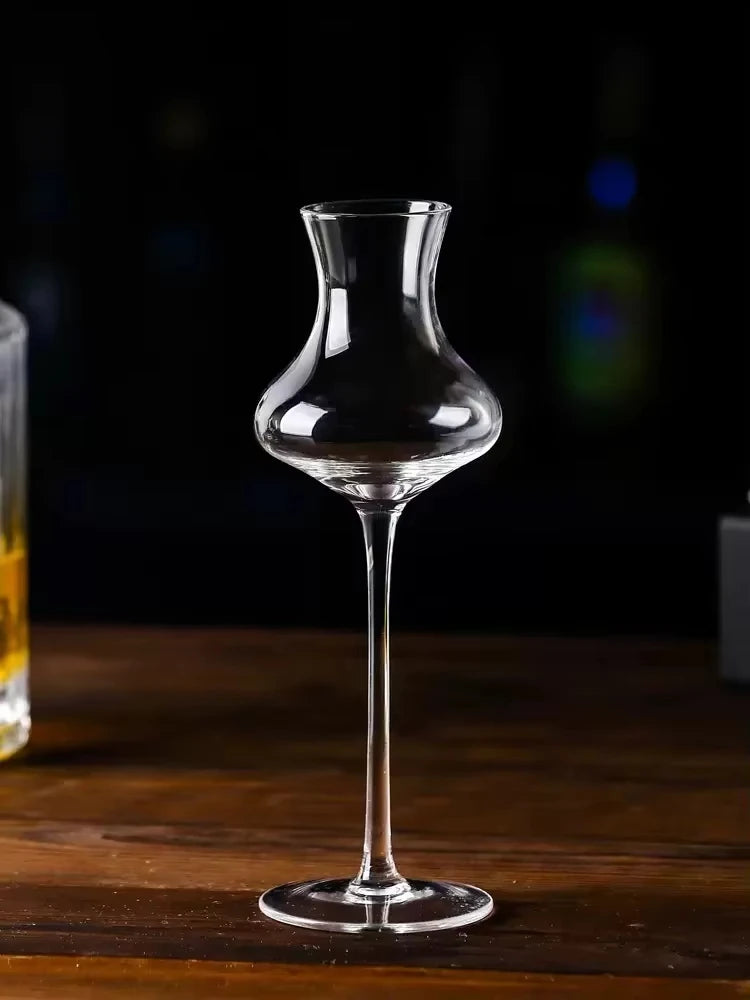 "Slender" crystal spirits glass placed on a table, sleek elongated silhouette — CL House Drinkware collection