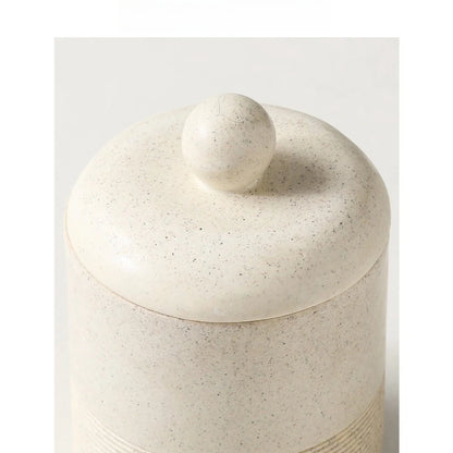 Close-up top view of Chalk Stone ceramic storage jar showing domed lid with round ball knob and speckled stone texture detail, on light grey background