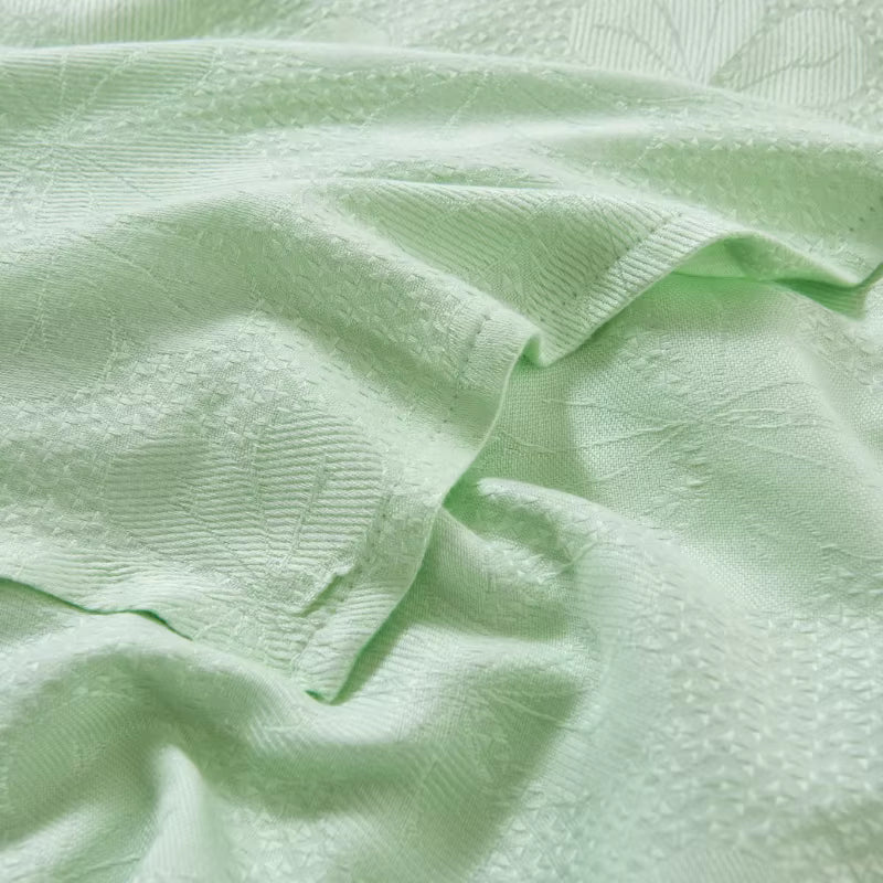 Close-up of jacquard woven texture on "Aqua Weave" bamboo fibre cooling blanket in Sage Mint — soft ribbed pattern with a silky smooth finish