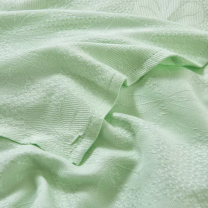 Close-up of jacquard woven texture on "Aqua Weave" bamboo fibre cooling blanket in Sage Mint — soft ribbed pattern with a silky smooth finish