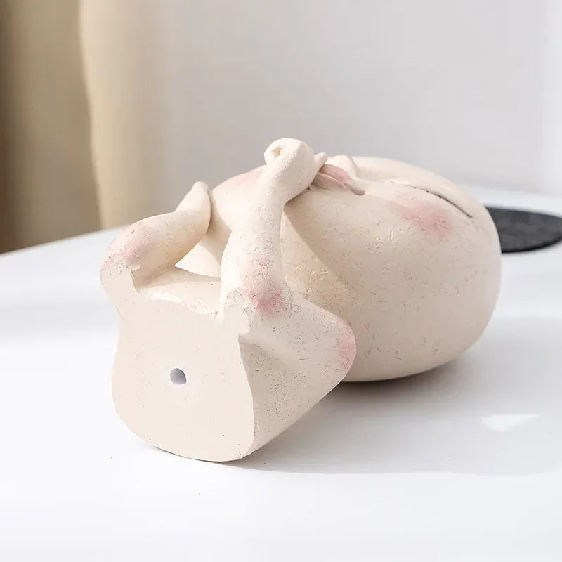 "Hush Muse" sculptural face resin planter base showing drainage hole and ivory cream textured resin finish
