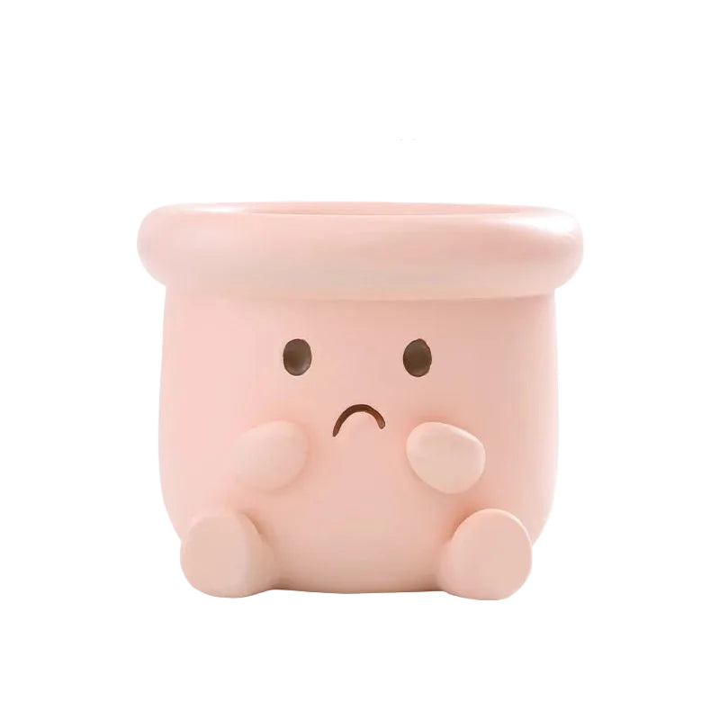 Happy Pot" sad face resin succulent planter in blush pink with worried expression, hands on cheeks and drainage hole, white background