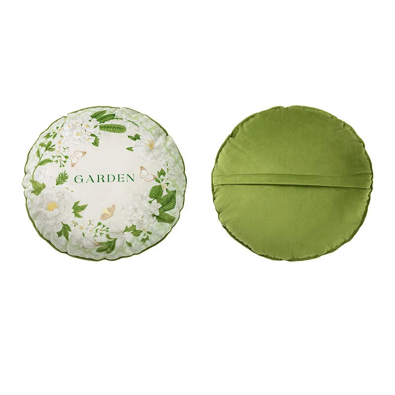  "Garden Whisper" cushion cover, Jasmine Garden Round design — white ground with wreath of white jasmine flowers, green foliage and golden butterflies, green "GARDEN" script at centre, scalloped green edge, plain green reverse

