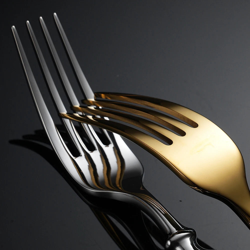 Close-up detail of "Twisted Rope" dinner forks in Silver and Gold finish side by side — showing the polished stainless steel tines and reflective surface contrast