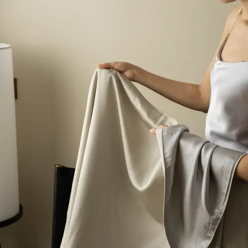  Close-up of Blush Taupe 100% Tencel cooling summer blanket showing silky smooth fabric texture and fluid drape