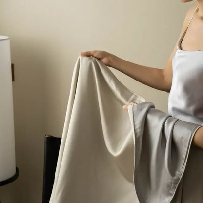 Close-up of Blush Taupe 100% Tencel cooling summer blanket showing silky smooth fabric texture and fluid drape