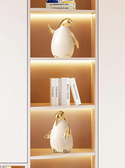 "Arctic Family" ceramic penguin styled on bookshelf, CL House
