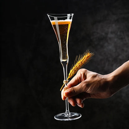 Hand holding a "Trumpet" crystal champagne flute, elegant elongated silhouette — CL House Drinkware collection